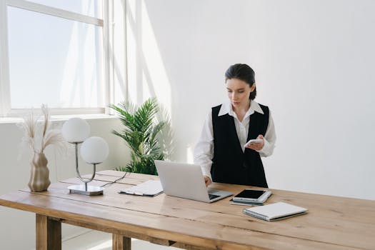 A person using a laptop and tablet to work remotely